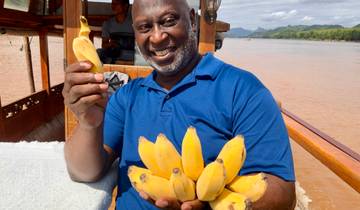 Person posing with traditional dancers.