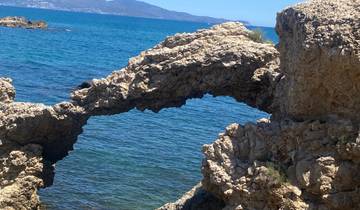 Rock formation arch by the blue sea.