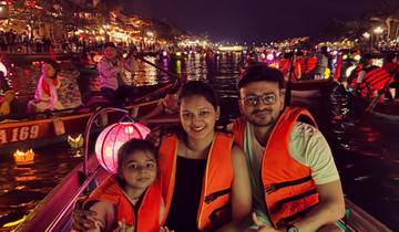 Family on a boat during a night lantern festival.