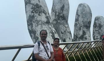 Couple posing on the Golden Hand Bridge.