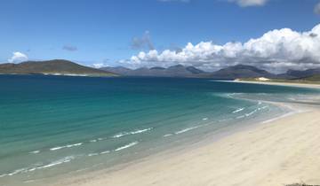 Wide view of a pristine beach with turquoise water.