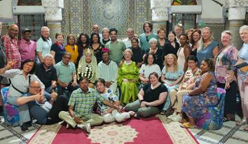 Group gathered in a beautifully tiled room, smiling for the camera.