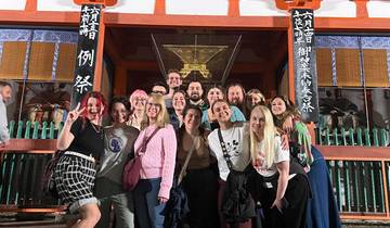Group of people posing in front of a temple.