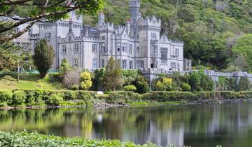 Castle-like building reflecting in a lake.