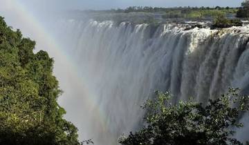 Victoria Falls with a rainbow over the waterfall.