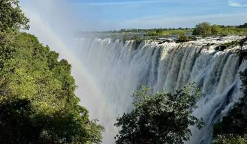 Victoria Falls with a rainbow across the mist.