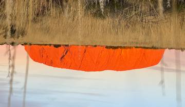 Uluru rock formation glowing red at sunset.
