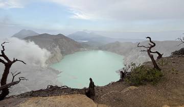 Crater lake with cloudy skies and distant mountains.