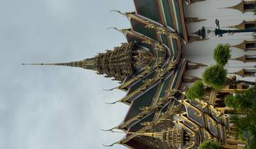 Intricately designed golden temple with pointed spires.