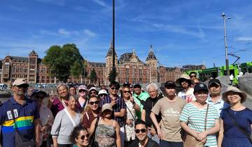 Group posing in front of historic European buildings.