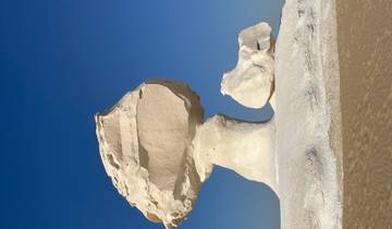 Unique mushroom-shaped rock formation in a desert.