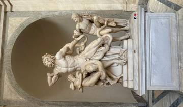 Ancient marble statue in a museum setting.