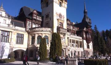 Large historic castle with clock tower and intricate design.