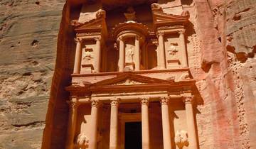 Petra's iconic rock-carved Treasury building in a canyon.