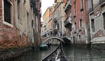 Gondola navigating a canal with historic buildings in Venice.