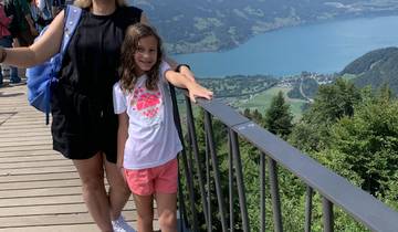 Child with an adult on a bridge with panoramic view.
