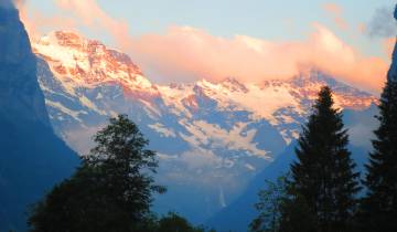 Snow-capped mountains during sunrise.