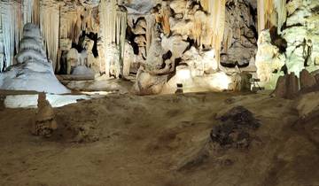 Interior of a rock cave with stalagmites.