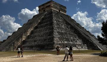 Tourists looking at the Pyramid of Kukulkan at Chichen Itza.
