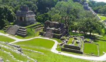 Ancient Mayan ruins surrounded by greenery.