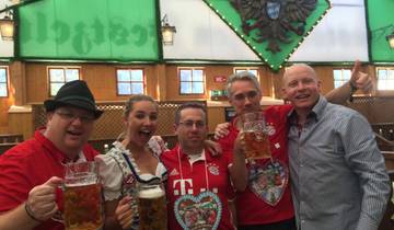 Friends celebrating with drinks in a festive setting wearing traditional attire.