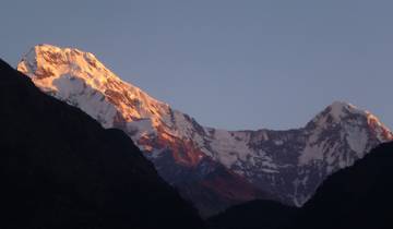 Close-up of snow-capped mountains at sunrise.
