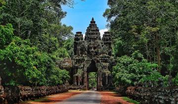 An ancient stone archway in a lush forest setting.