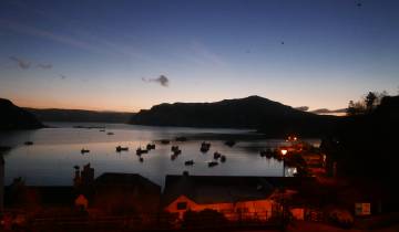Bay with boats and houses at twilight