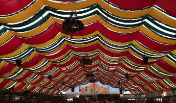 Colorful tent ceiling with hanging decorations.
