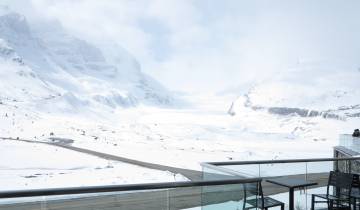 Snowy mountain view from a viewing deck.