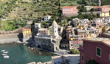Aerial view of a coastal town with colorful buildings and sea.