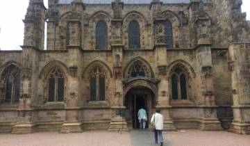 A Gothic-style cathedral facade with ornate arches and doors.