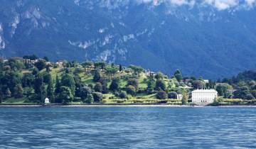 Scenic view of an island with lush greenery and a villa.