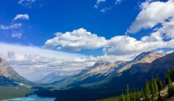 Mountain range with a valley and a river in the distance.