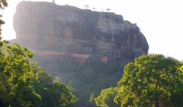 Sigiriya Rock rising above the forest.
