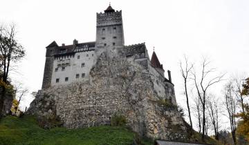 A large stone castle perched on a rocky hillside.