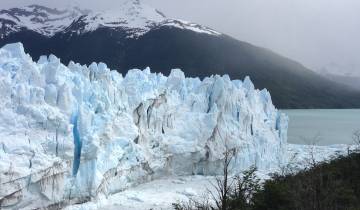 Glacier view with ice formations over a lake.