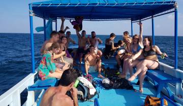 Group of people on a boat enjoying the ocean.