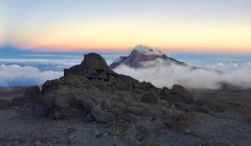 Rocky summit with clouds at sunset on Mount Kilimanjaro.