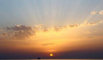 Beautiful sunset over the horizon with rays of sunlight.