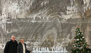 Two people in front of a sign reading 'Salina Turda'.