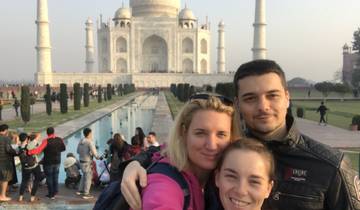 People posing with the Taj Mahal in the background.