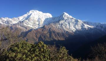Majestic snow-capped mountains with clear blue sky.