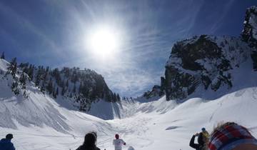 Sunlit snowy landscape with clear skies.