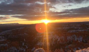 Sunrise over a snow-dusted canyon landscape.