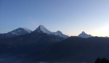 Scenic mountains with snow caps during sunrise.