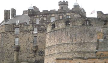 Historic stone castle with towers and a flag.