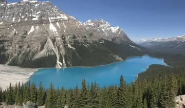 Scenic lake view with steep mountain backdrop.