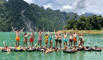 Group of people enjoying a floating platform on a lake.