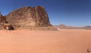 Vast desert landscape with large rock formations.